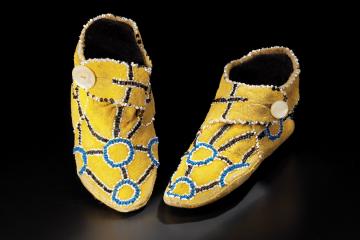 Deer hide, ochre, beads, mother-of-pearl buttons.