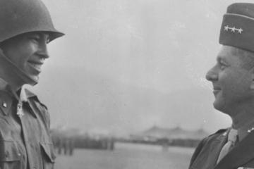 Lt. Ernest Childers being congratulated by Gen. Jacob L. Devers